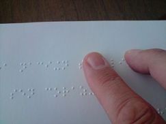 320px-A_person_reading_a_braille_book